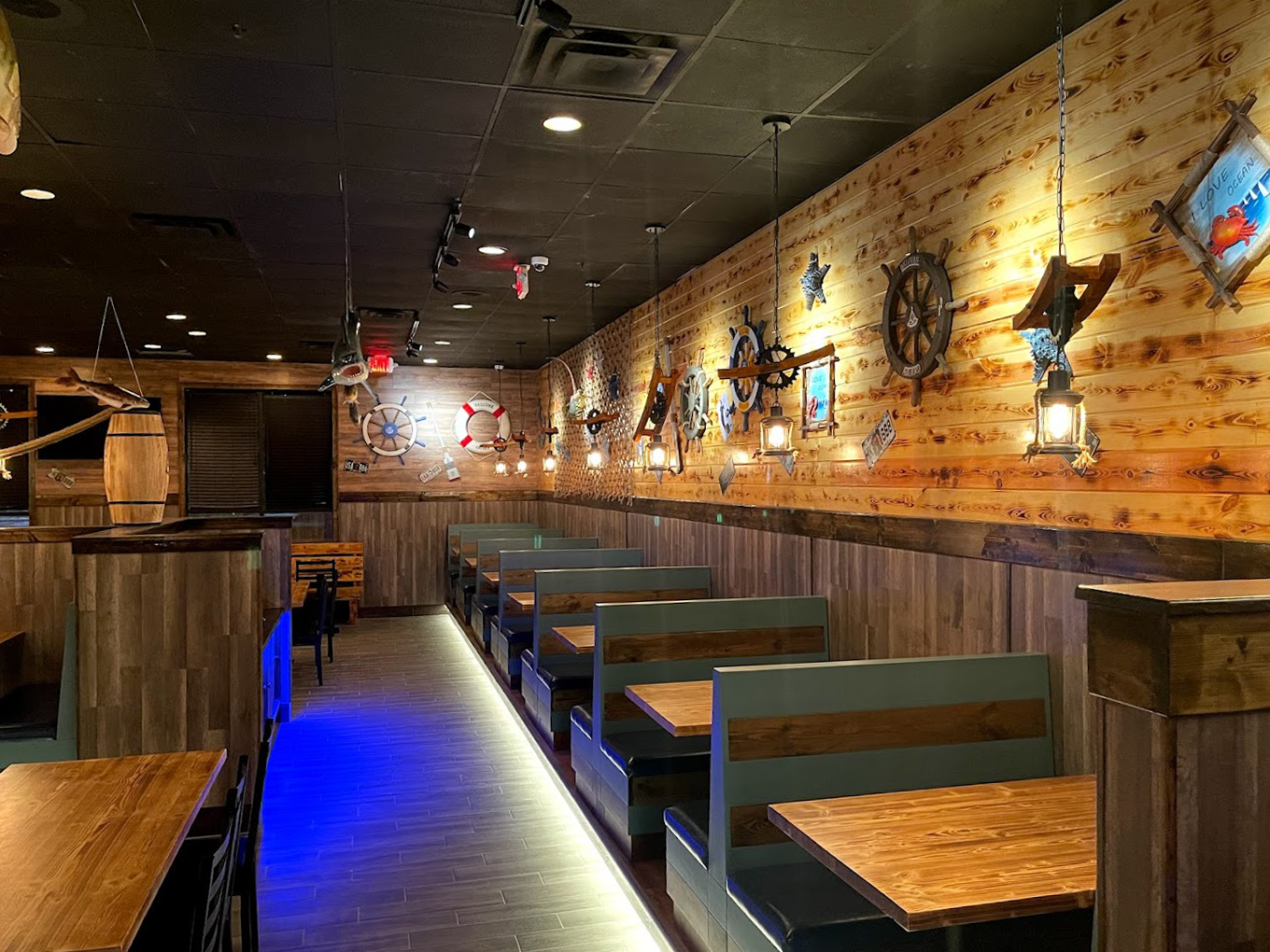 Front restaurant technology customer success Juicy Seafood restaurant interior with multiple booth seating along a wall