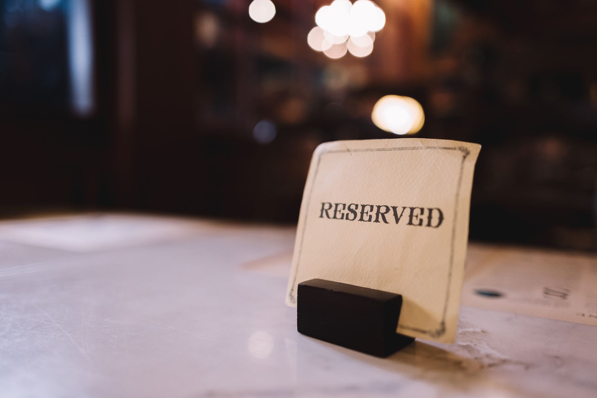 The restaurant owner has kept the table that a guest has booked.