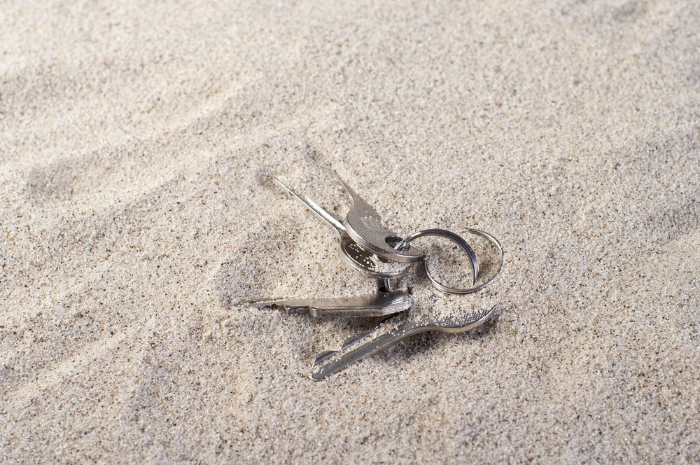 Silver Metal Clothespin in Light Brown Sand — Cairns Locksmiths in Trinity Beach, QLD