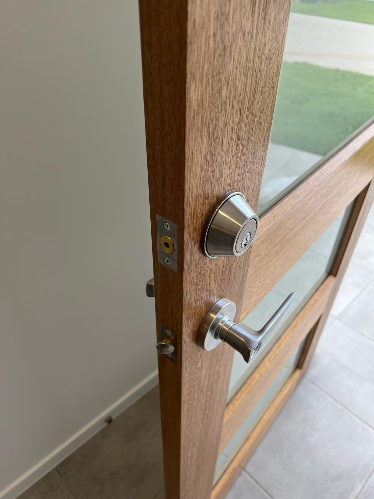 Wooden door with a silver handle and lock — Cairns Locksmiths in Edmonton, QLD