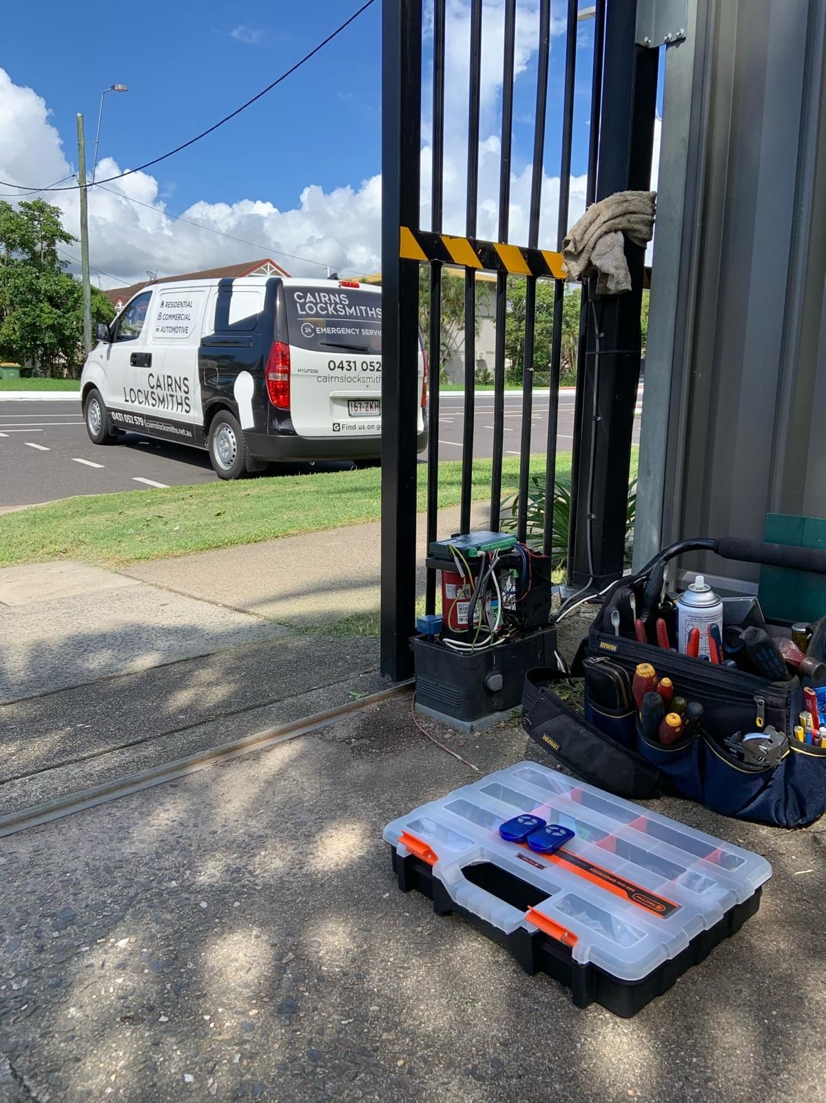 Lock Cylinder and Blue Key on Patterned Surface — Cairns Locksmiths in Woree, QLD