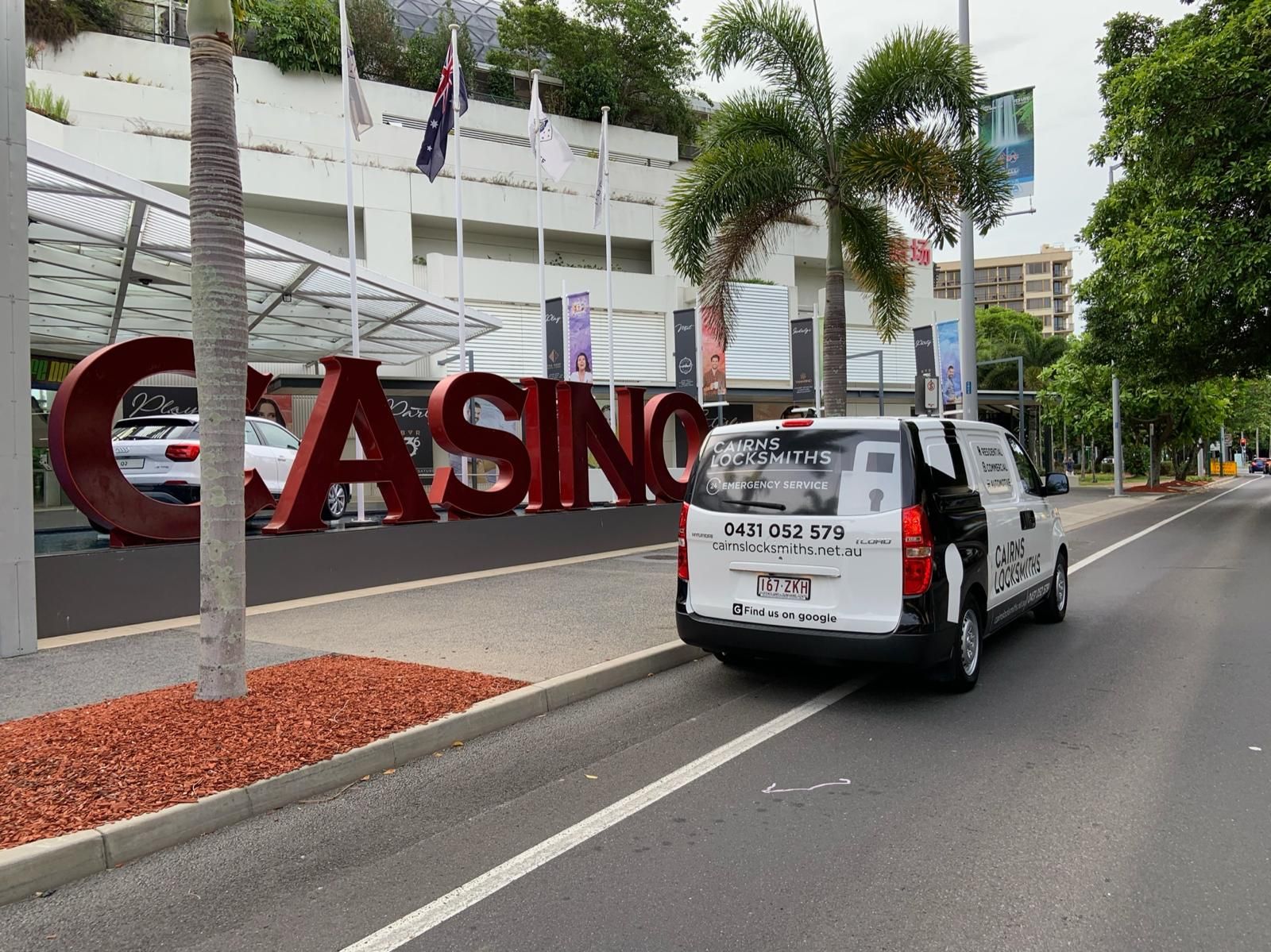 Hands Holding a Silver Key — Cairns Locksmiths in Palm Cove, QLD