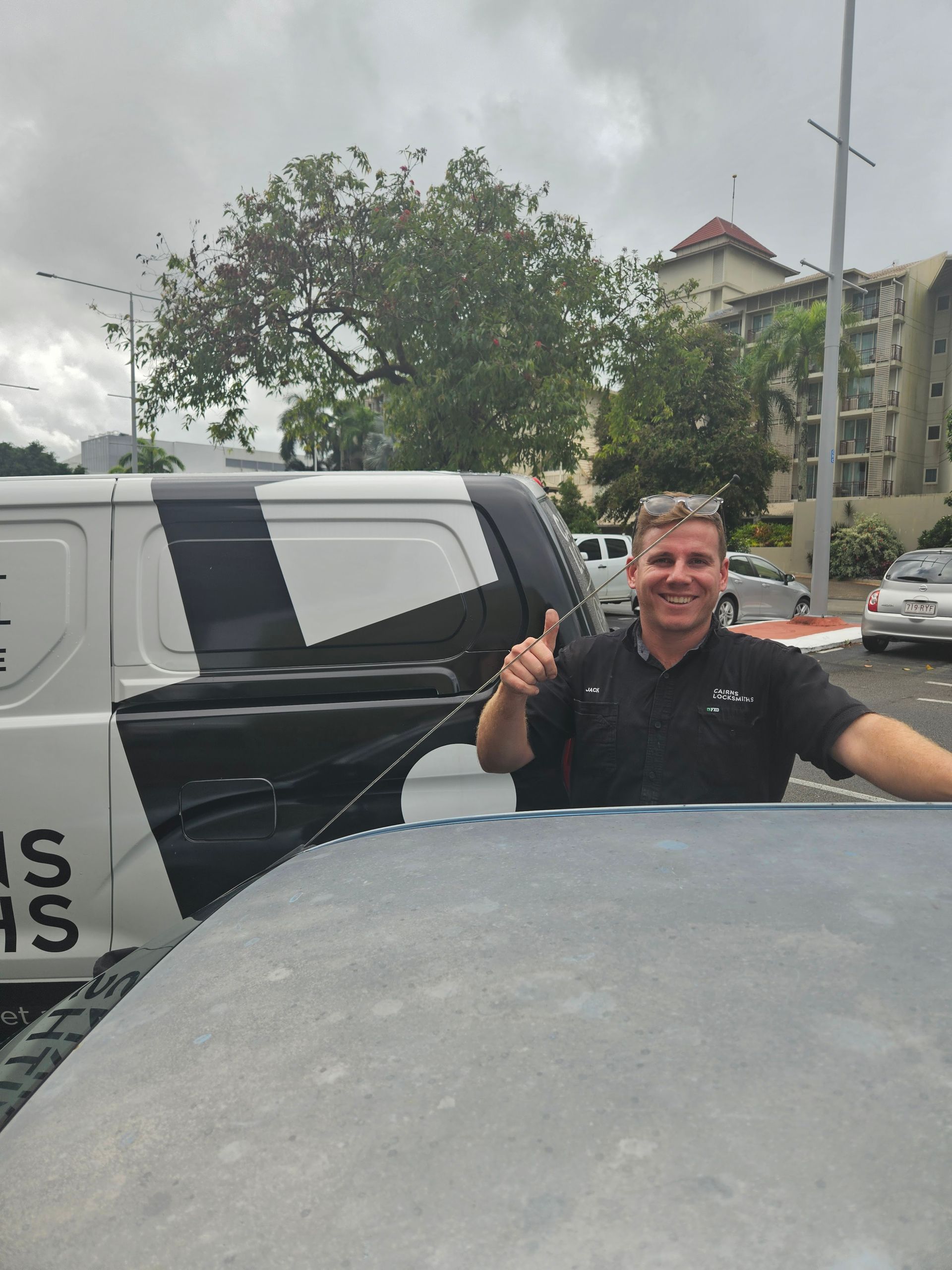 Man Giving Thumbs Up Next to a Black and White Van, Outside in a Parking Lot — Cairns Locksmiths in Gordonvale, QLD