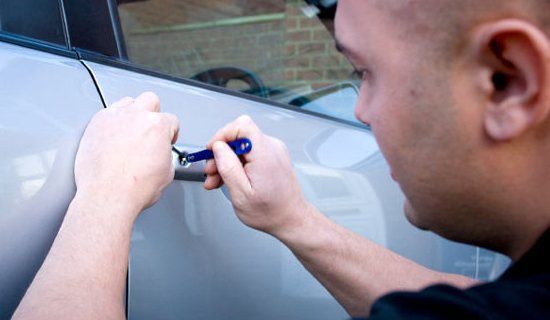 Man Using Tools to Unlock a Car Door — Cairns Locksmiths in Smithfield, QLD