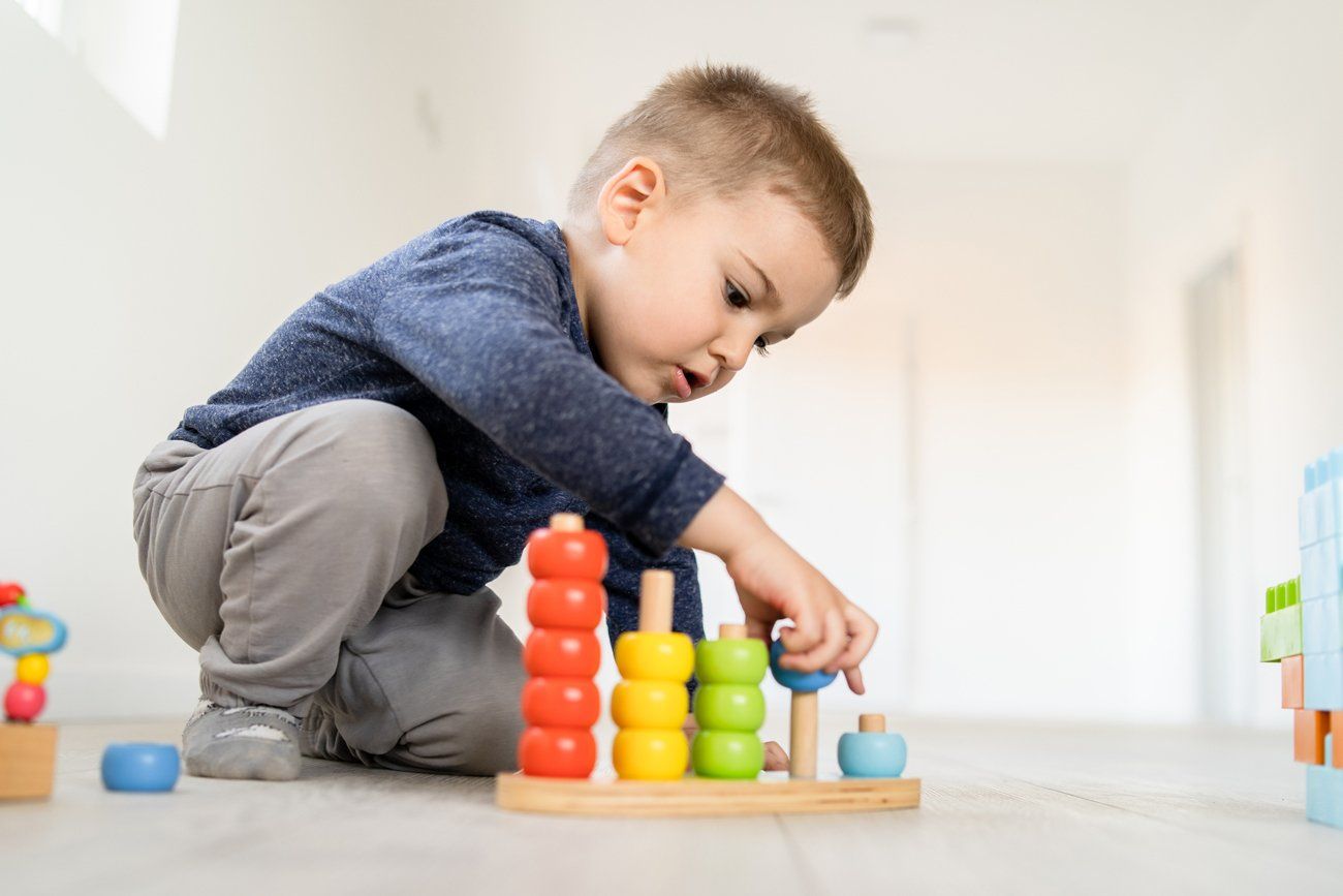 Small Boy Playing Wooden Toys — Belleville, IL — Toddle Town, Inc.