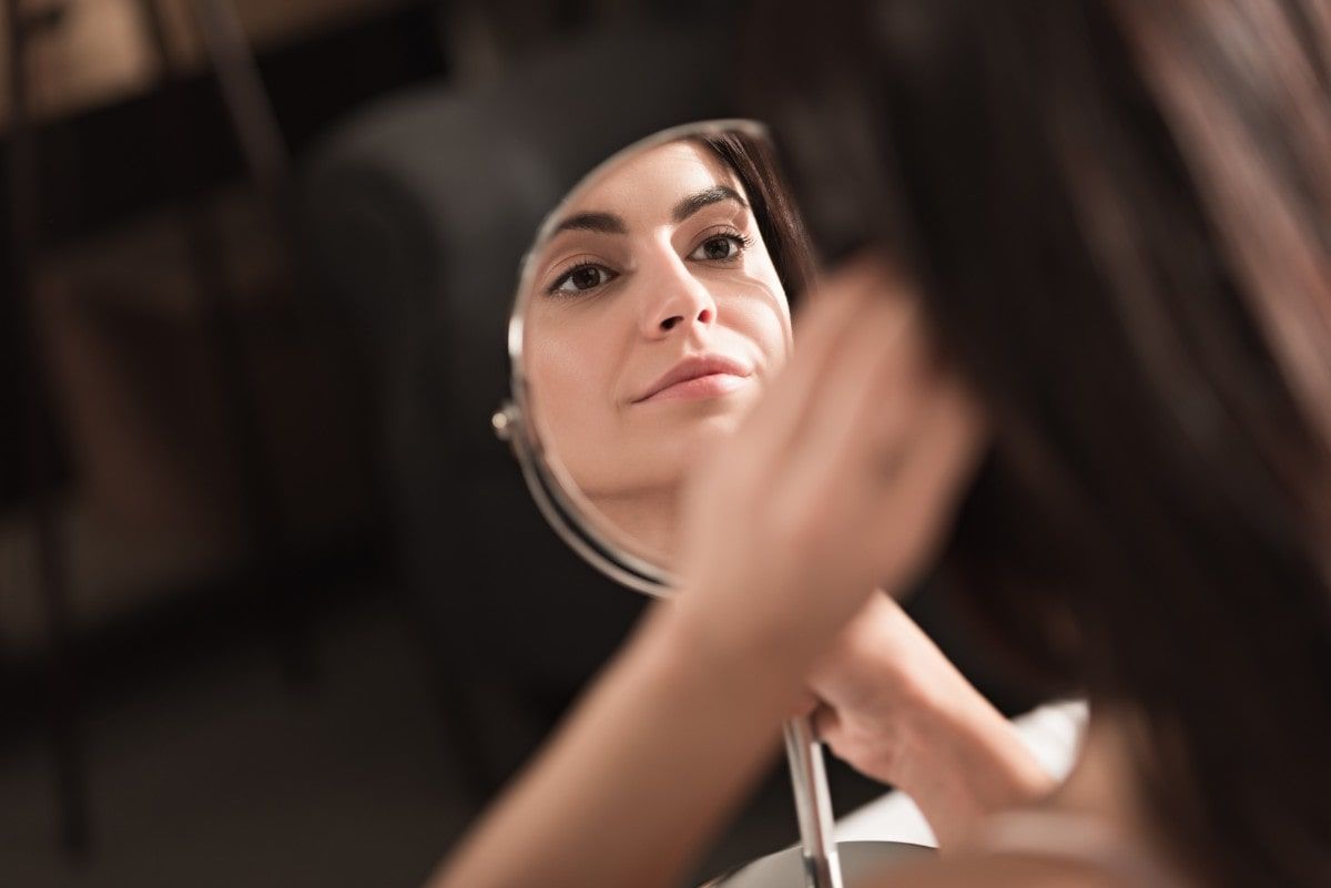 Woman Looking At The Mirror — Jacksonville, FL — Ageless Rejuvenation Center