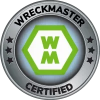 WreckMaster Certified badge with green WM logo in a silver circular emblem