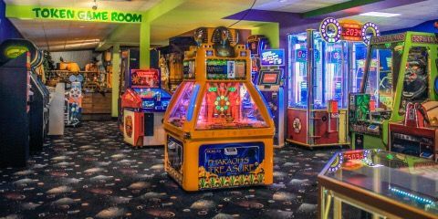 An arcade with a lot of games and a token game room.