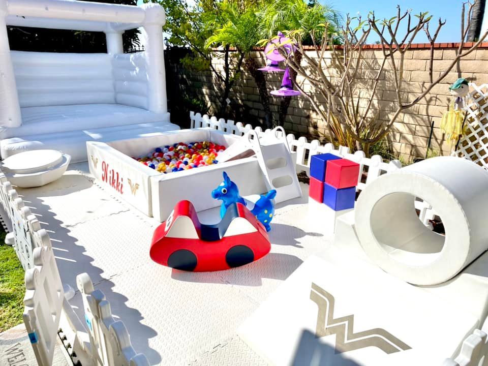 A table with toys and a bouncy castle on it.