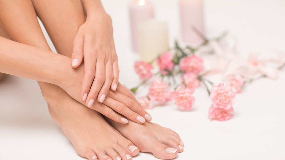 A woman is getting her nails done at a nail salon.
