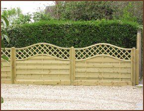   fence with trellis detailing infront of green hedging