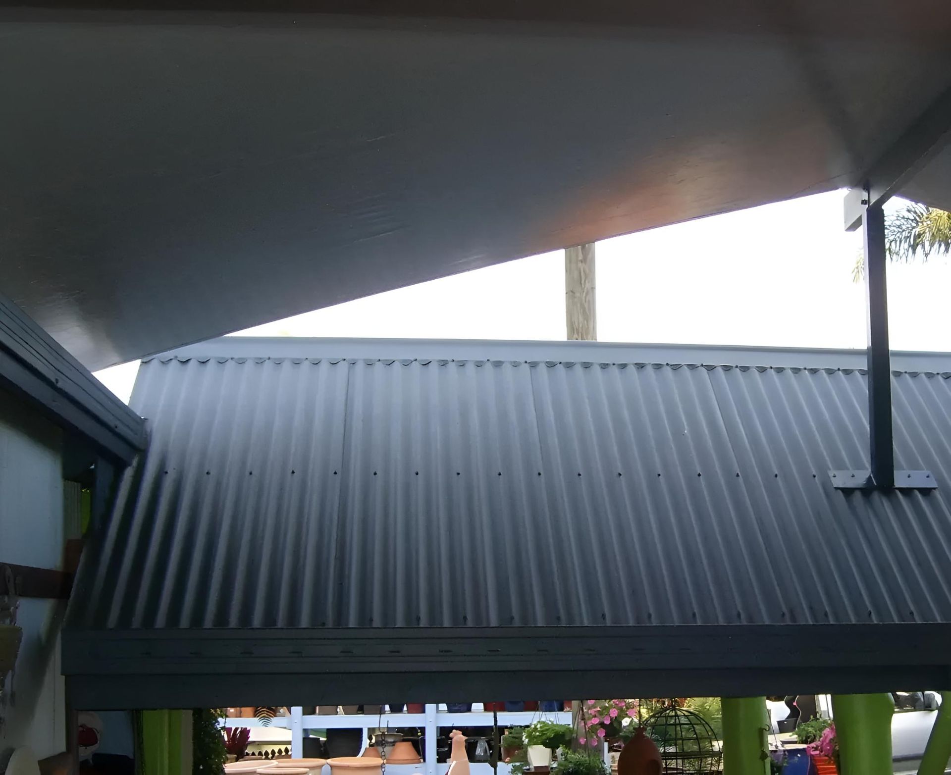 A Gray Roof With a White Awning Over It — Style Shades Installation In Dimbulah, QLD