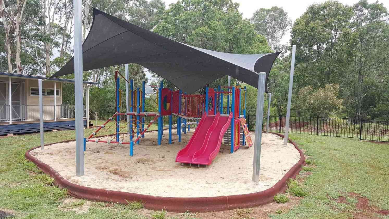 A Playground With A Slide Under A Canopy In A Park — Style Shades Installation In Edmonton, QLD