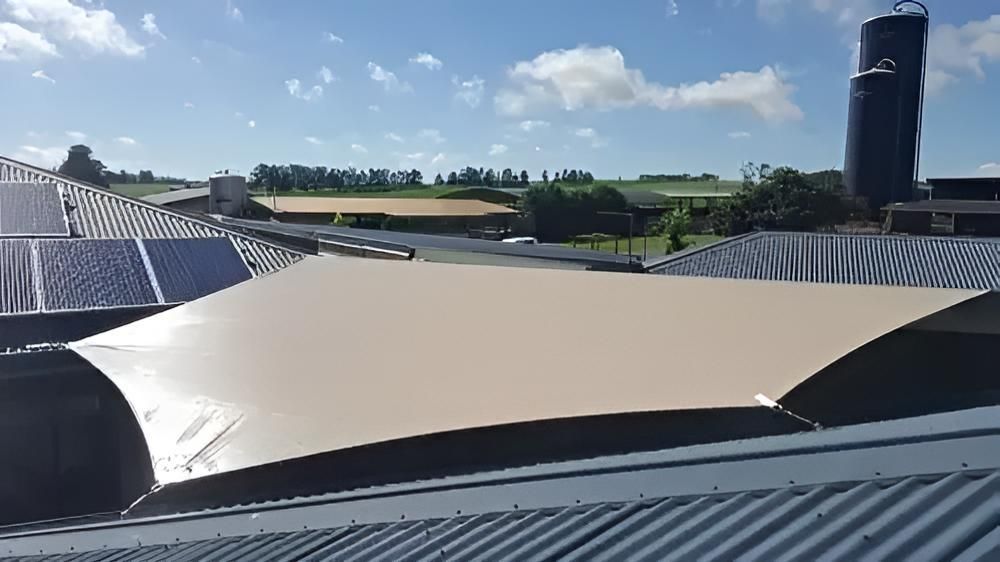 A Large Umbrella is Sitting on Top of a Roof — Style Shades Installation In Dimbulah, QLD