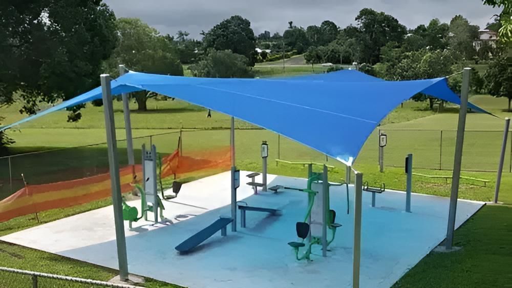 A Playground With a Blue Canopy Over It — Style Shades Installation In Dimbulah, QLD
