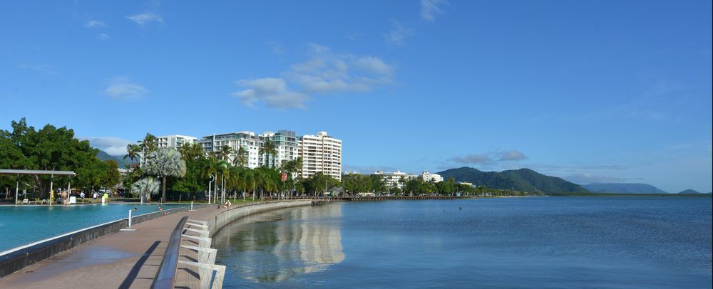 A Walkway Along a Body of Water With Buildings in the Background — Style Shades Installation In Smithfield, NSW