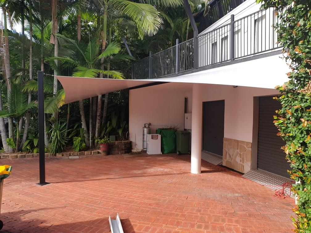 A White Building With A Roof That Has A Canopy Over It — Style Shades Installation In Edmonton, QLD