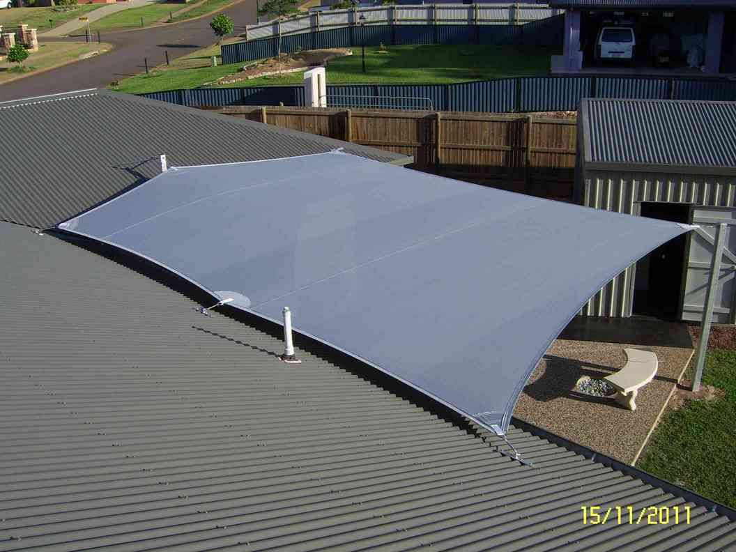 A Large White Umbrella Is Sitting On The Roof Of A House — Style Shades Installation In Edmonton, QLD