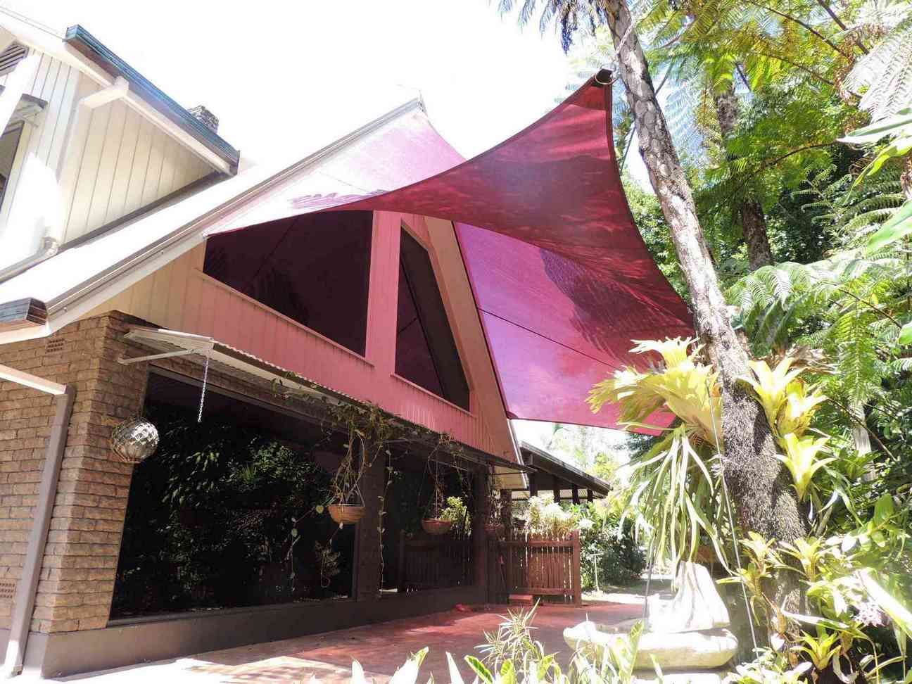 A House With A Red Awning On The Side Of It — Style Shades Installation In Edmonton, QLD