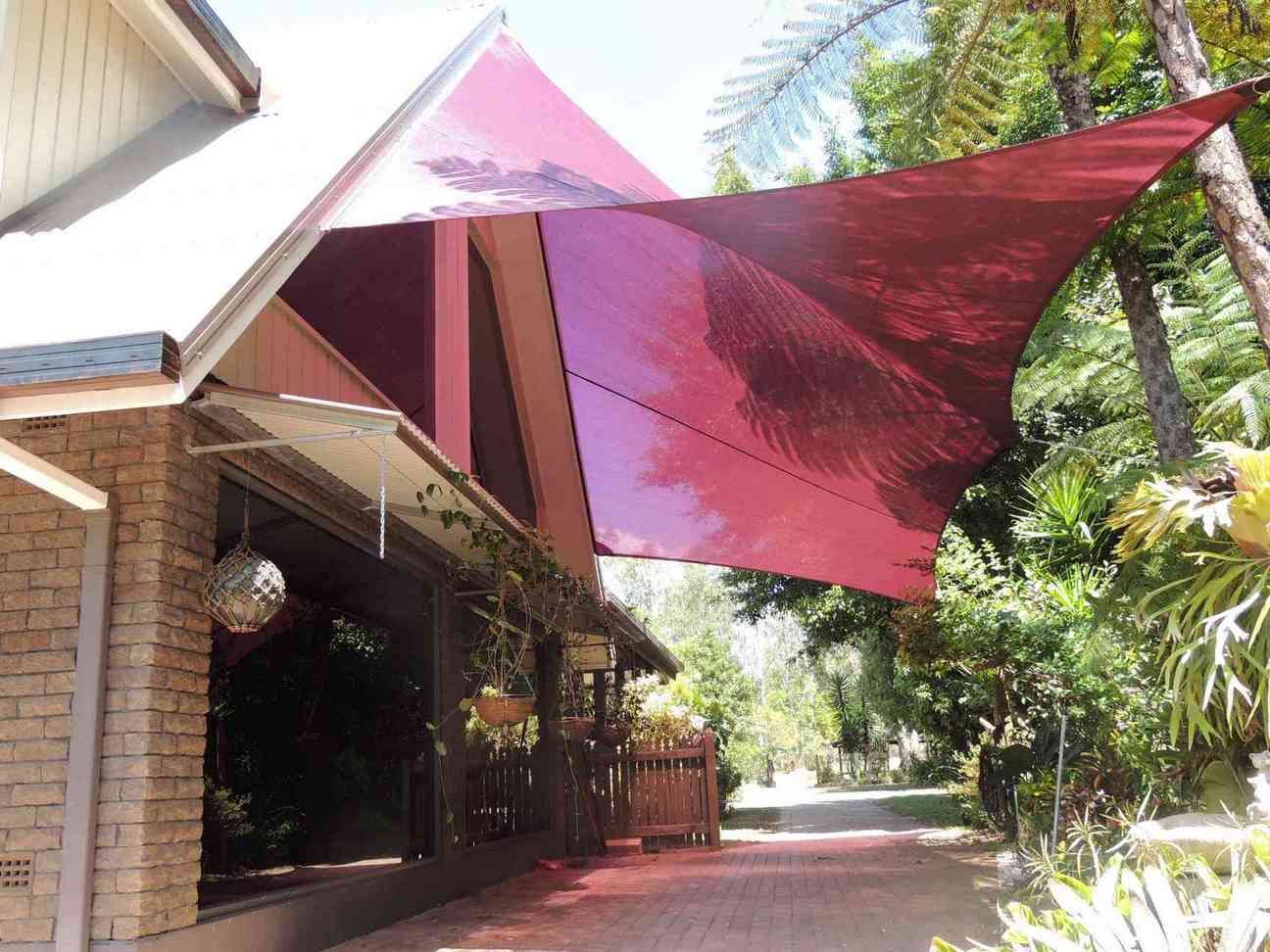 A Brick House With a Purple Awning Over It — Style Shades Installation In Smithfield, NSW