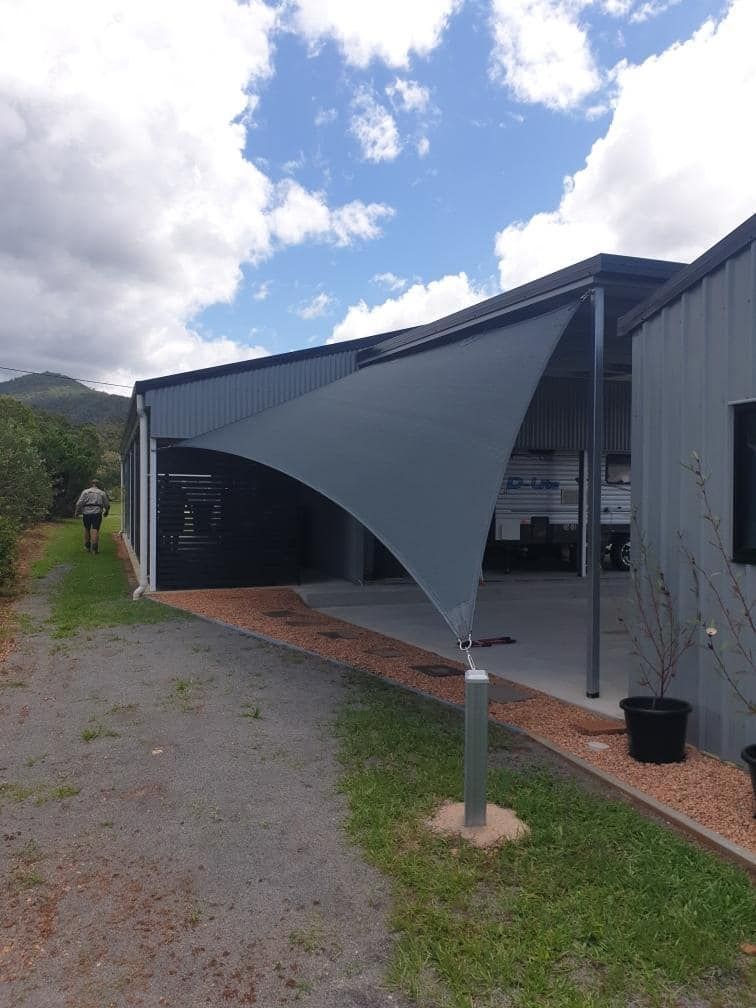 A Building With A Shade Sail On The Side Of It — Style Shades Installation In Edmonton, QLD