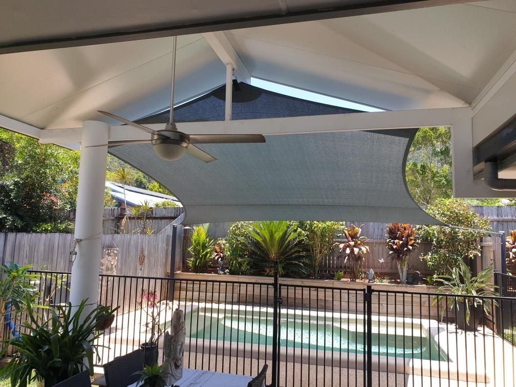 A Patio With A Ceiling Fan And A Pool In The Background 	— Style Shades Installation In Atherton Tablelands, QLD