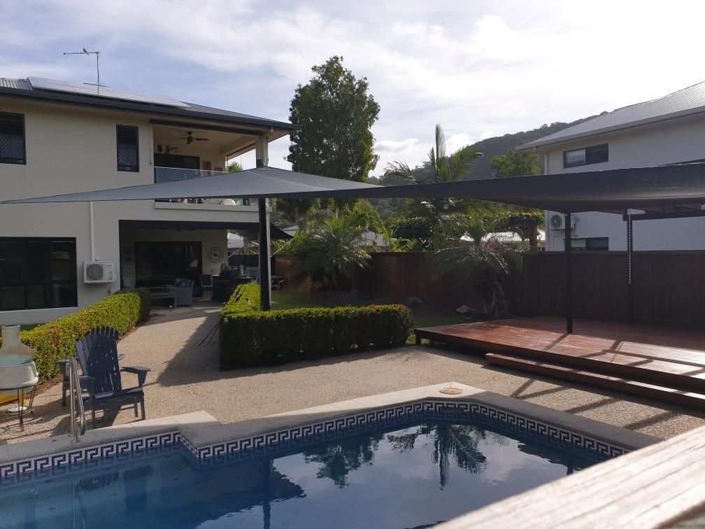 There Is A Large Swimming Pool In The Backyard Of A House — Style Shades Installation In Edmonton, QLD