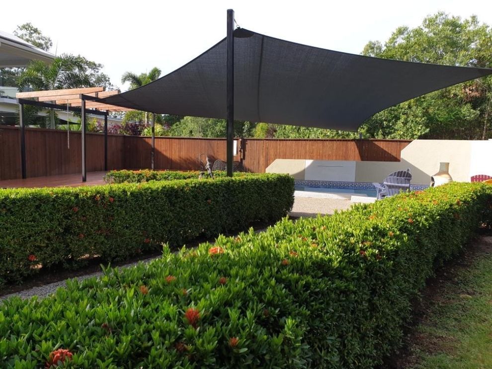 A Large Black Umbrella Is In The Middle Of A Garden — Style Shades Installation In Mareeba, QLD