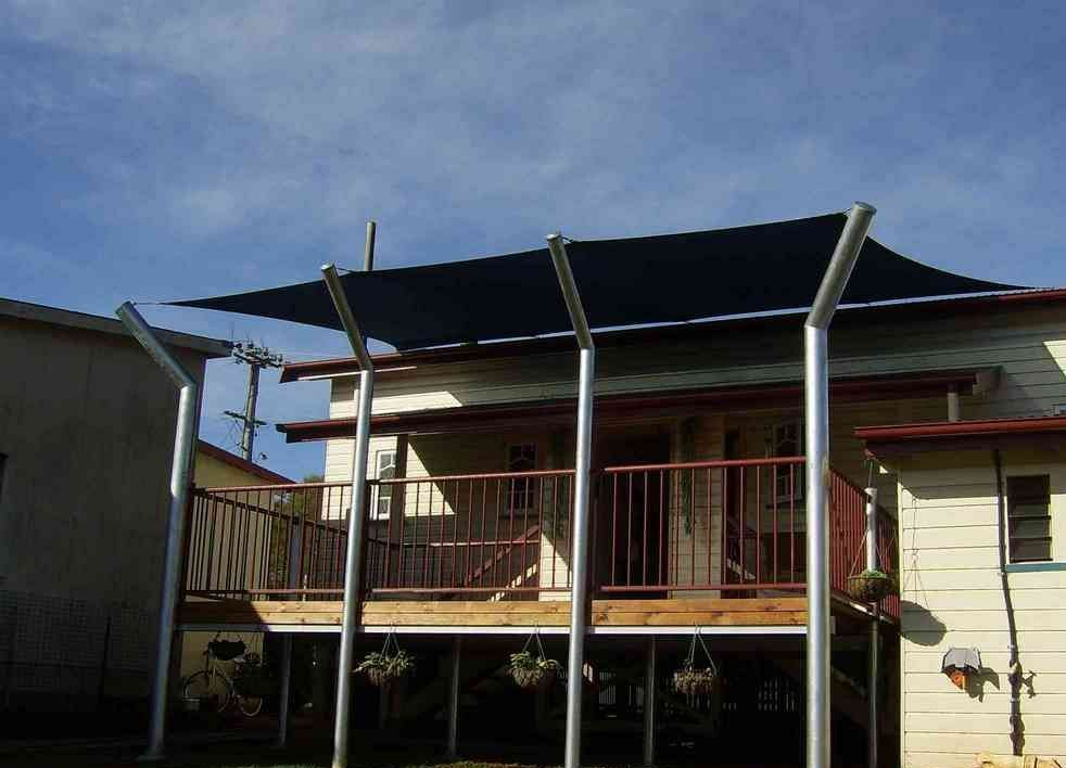 A Picture Of A House With A Blue Awning On It — Style Shades Installation In Edmonton, QLD