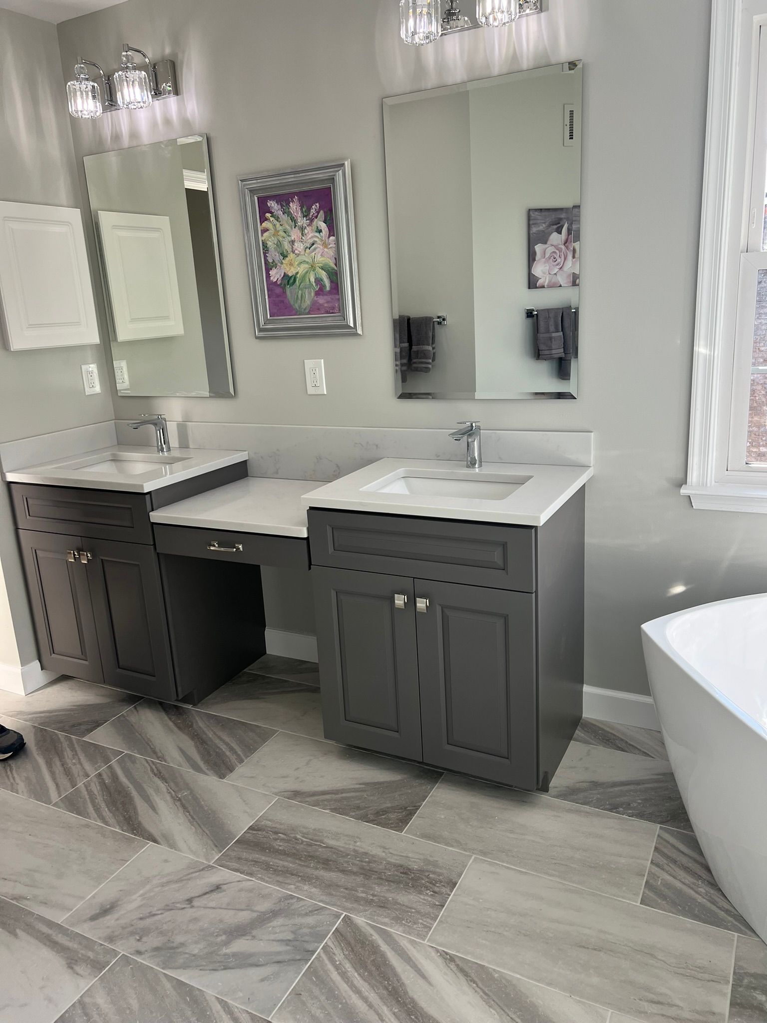 A bathroom with two sinks , two mirrors and a tub.