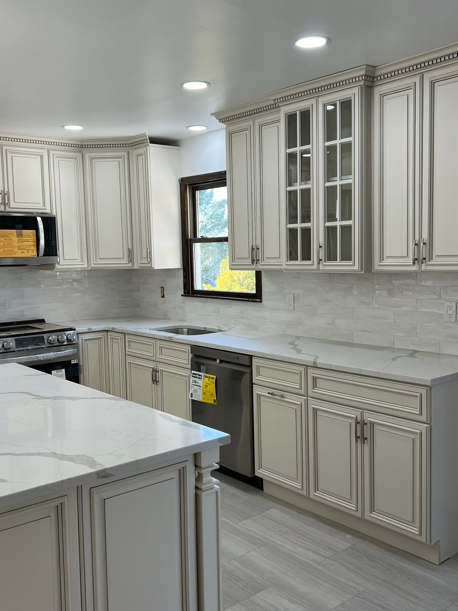 A kitchen with white cabinets and stainless steel appliances