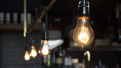 String of illuminated vintage light bulbs in a dark interior.
