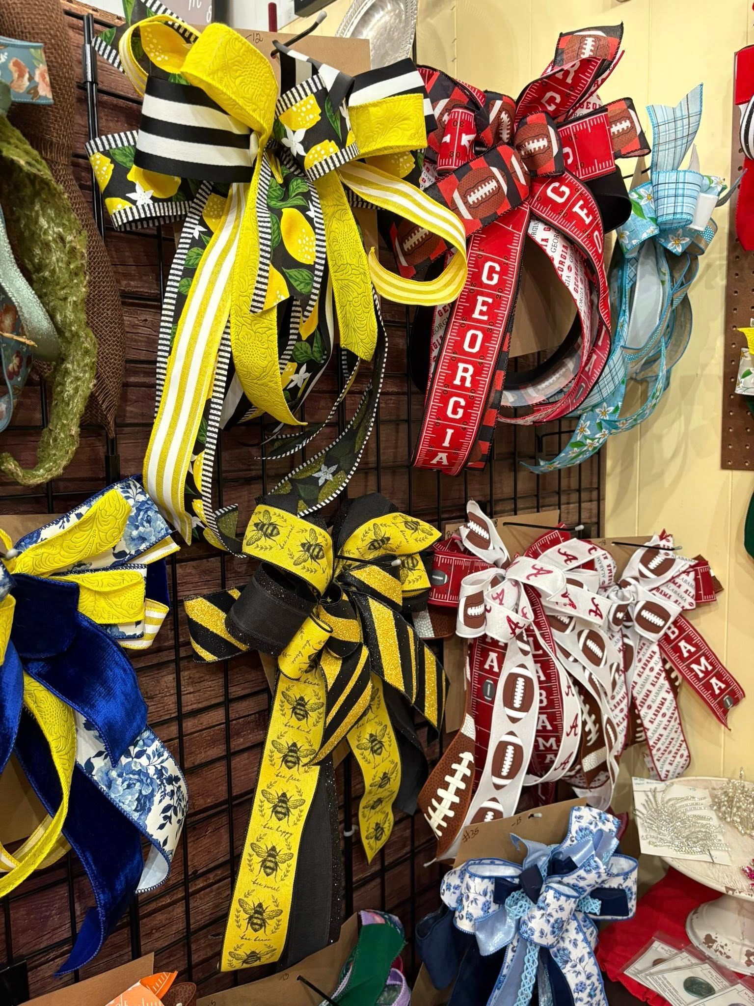 Colorful patterned dog leashes and harnesses hanging on a store display rack