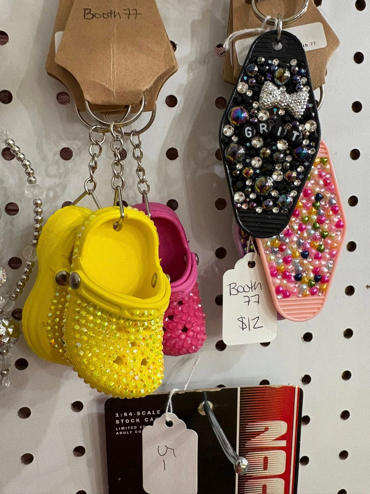 Colorful beaded keychains and small bags hanging on a pegboard display