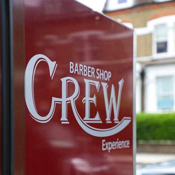 A red sign for the barber shop crew experience provided by Custom Signs & Signage by Fulham Signs 