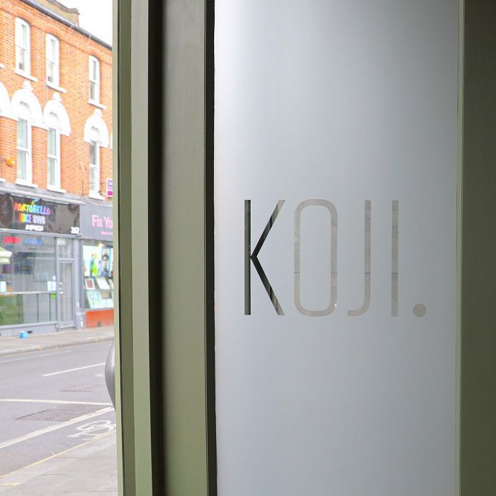 A window with the word koji on it Custom Signs & Signage by Fulham Signs 