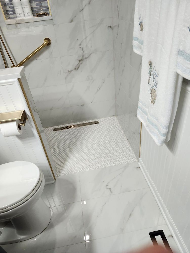 A bathroom with a toilet , sink , and shower.