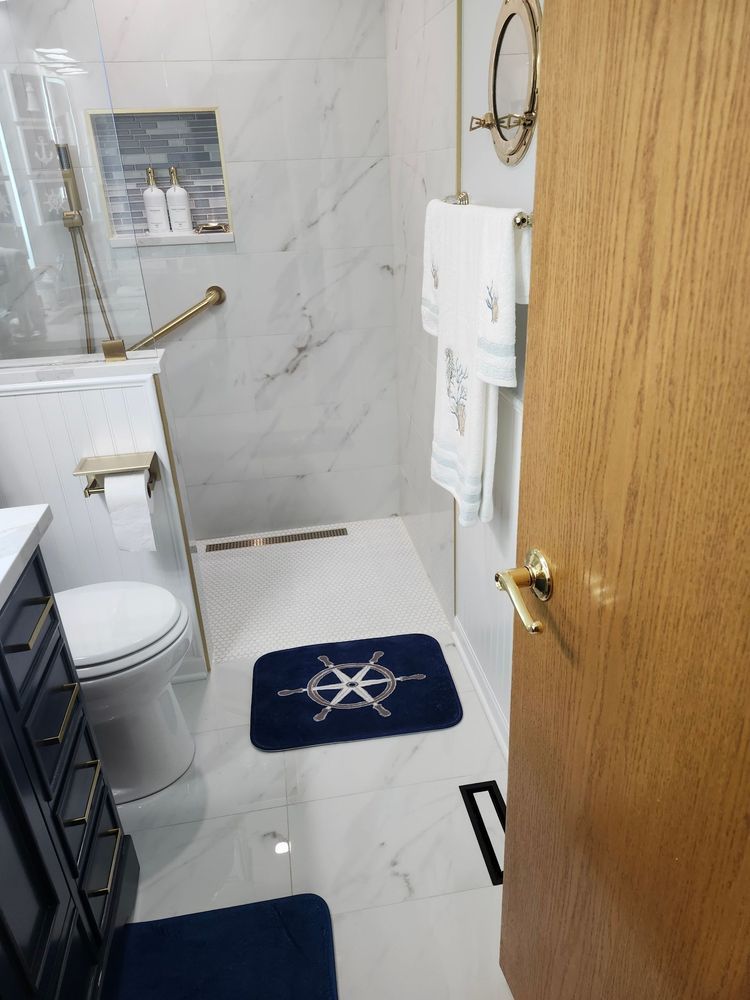 A bathroom with a toilet , sink , and shower.