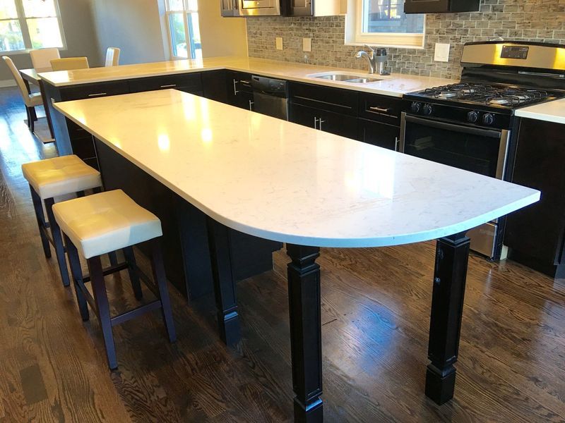 A kitchen with a large island and stools