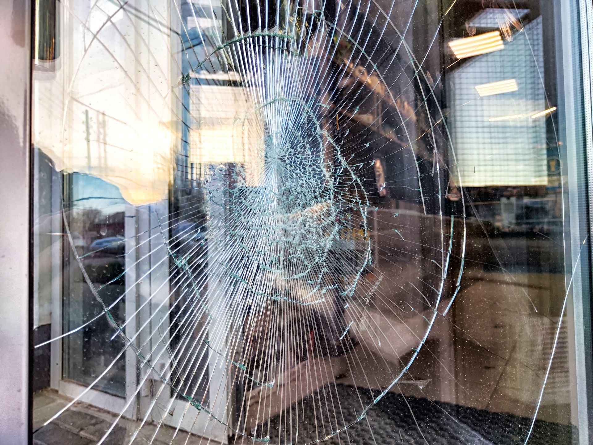 Storefront glass replacement being installed using suction cups for commercial window repair.