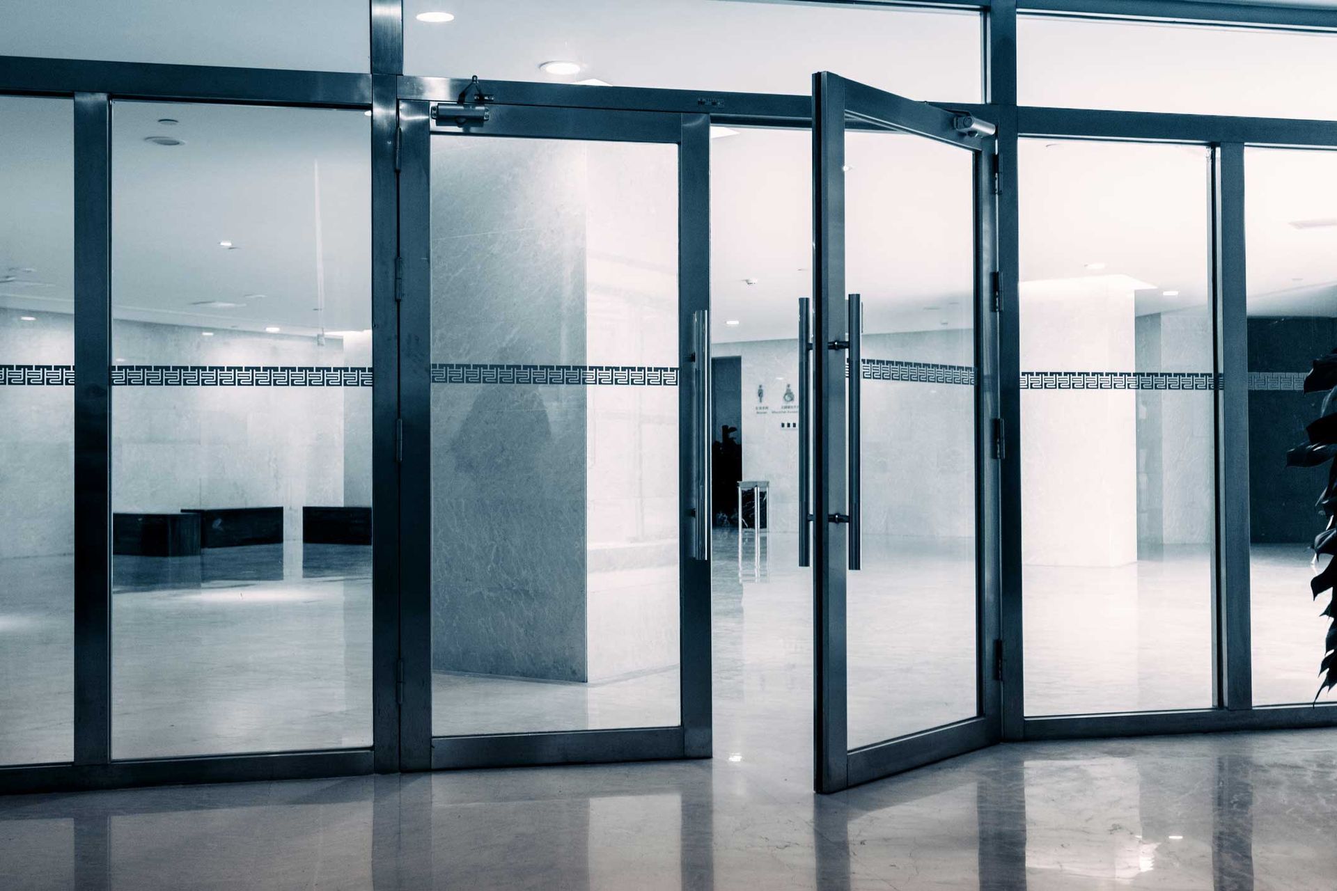 Glass doors open to a lobby.