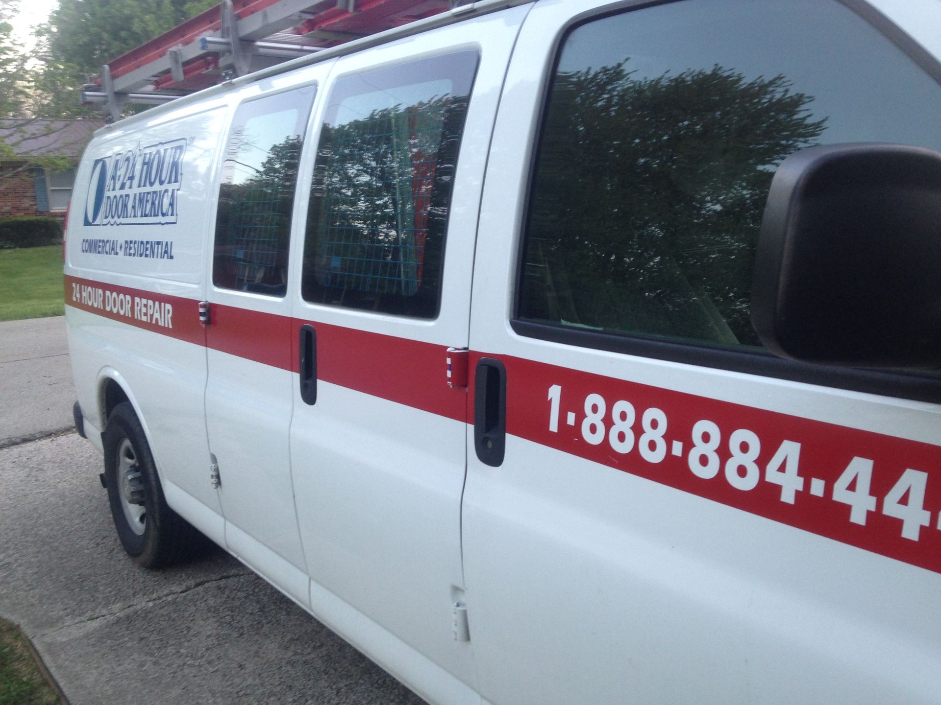 A-24 Hour Door America white service van. A-24 Hour Door America white service van.