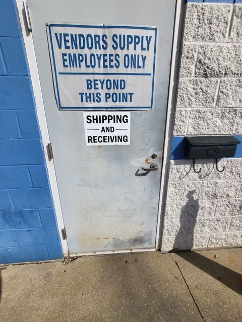 Metal door with Vendors Supply Employees Only sign. Metal door with Vendors Supply Employees Only sign.