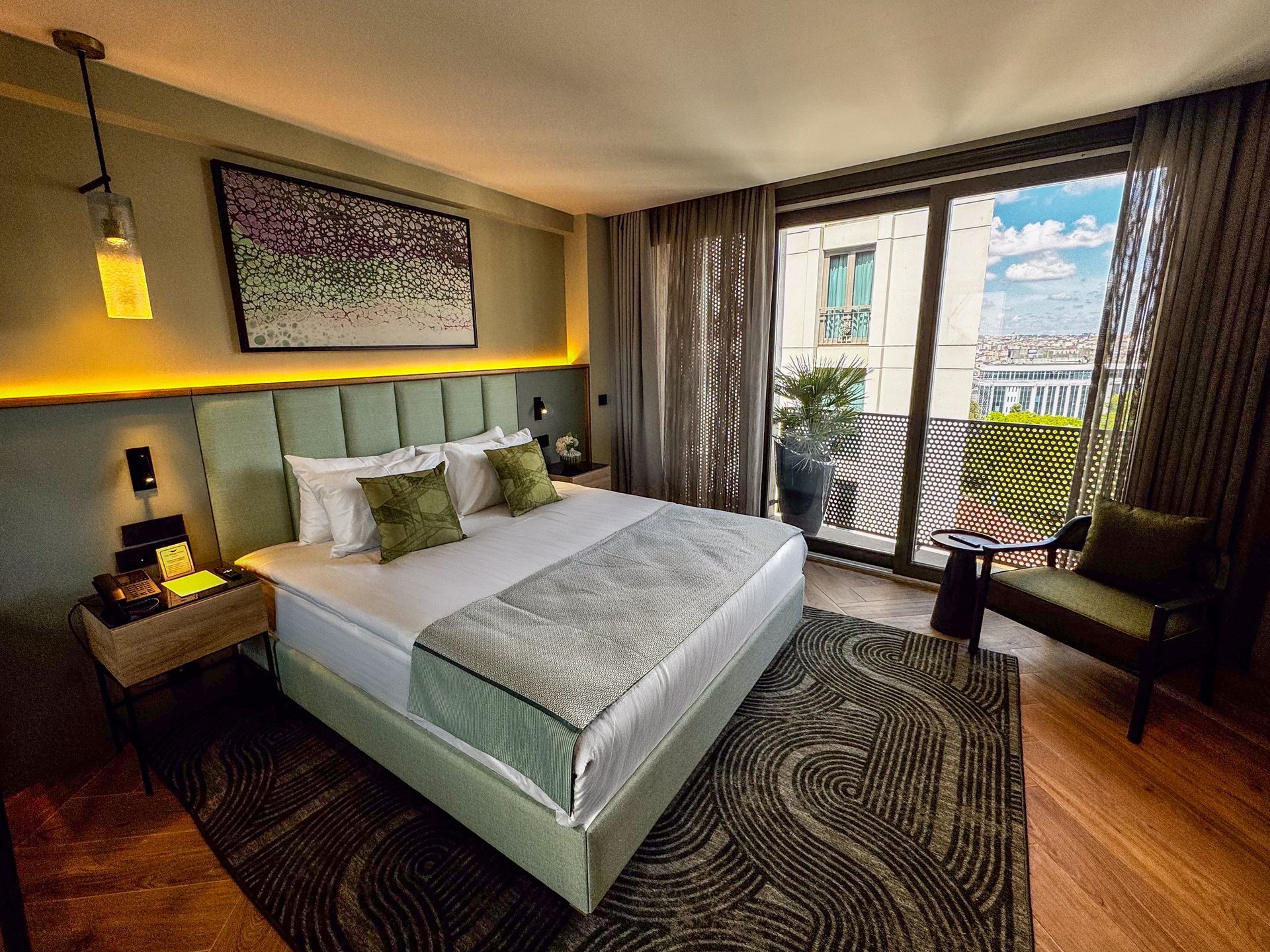 A hotel room with two beds , a chair , a desk and a mirror.