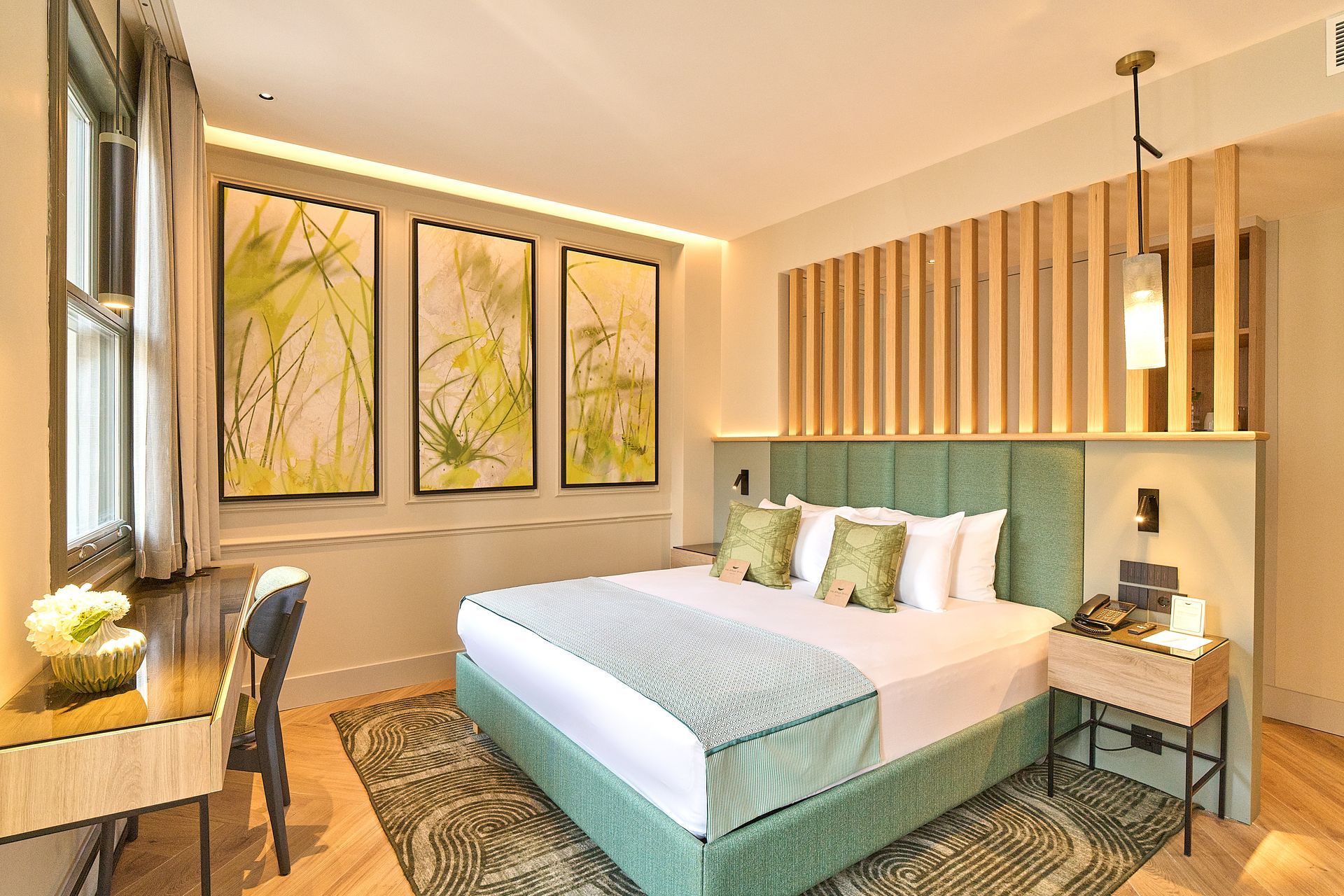 The Wings Hotels Pera | A hotel room with a large bed and a desk