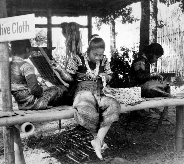 A group of people are sitting on a bench under a sign that says five cloth