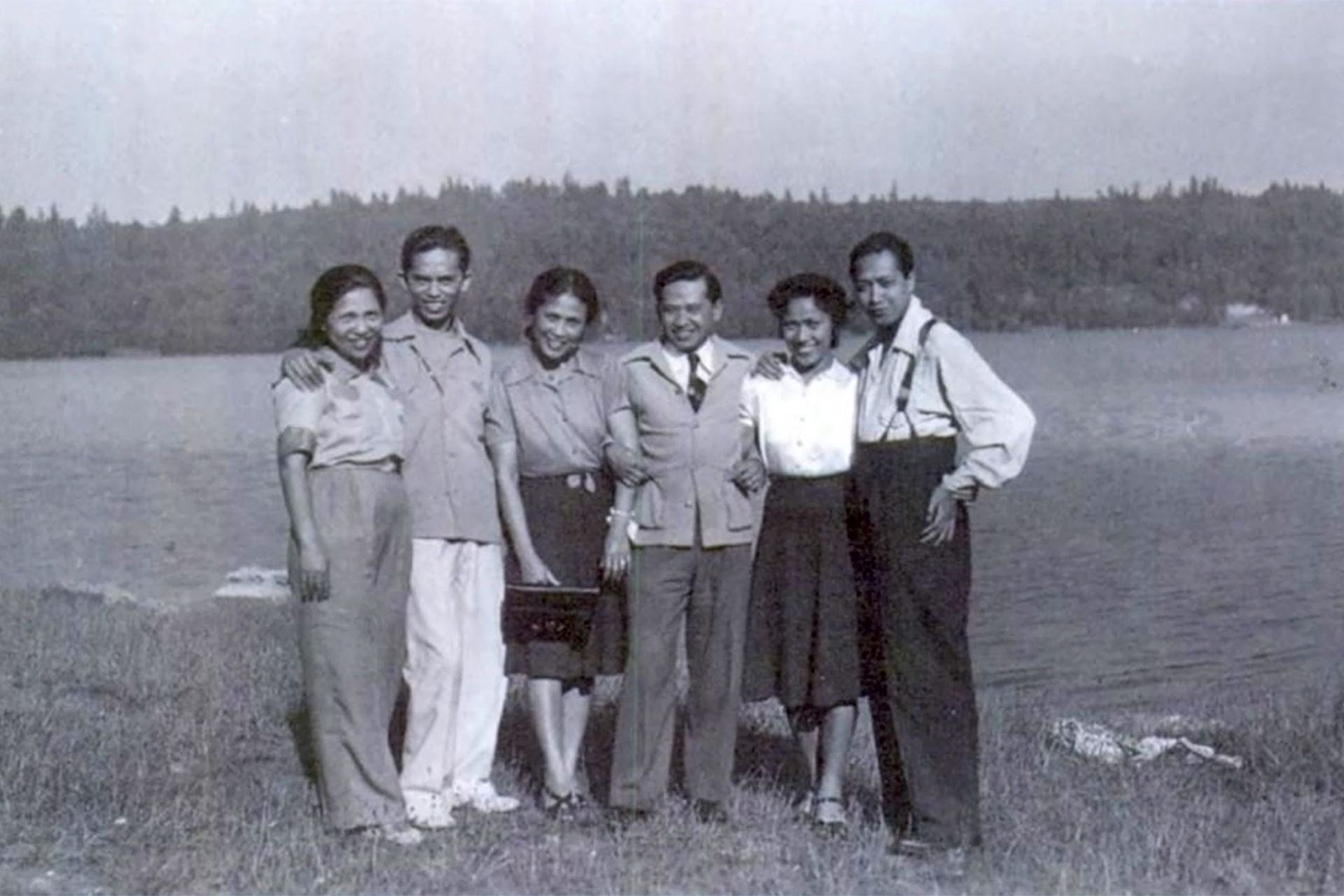 A group of people posing for a picture along the waterfront