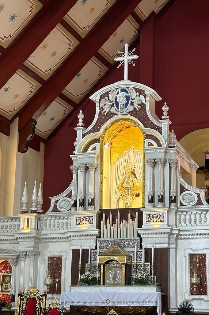 A large altar in a church with a cross on top of it