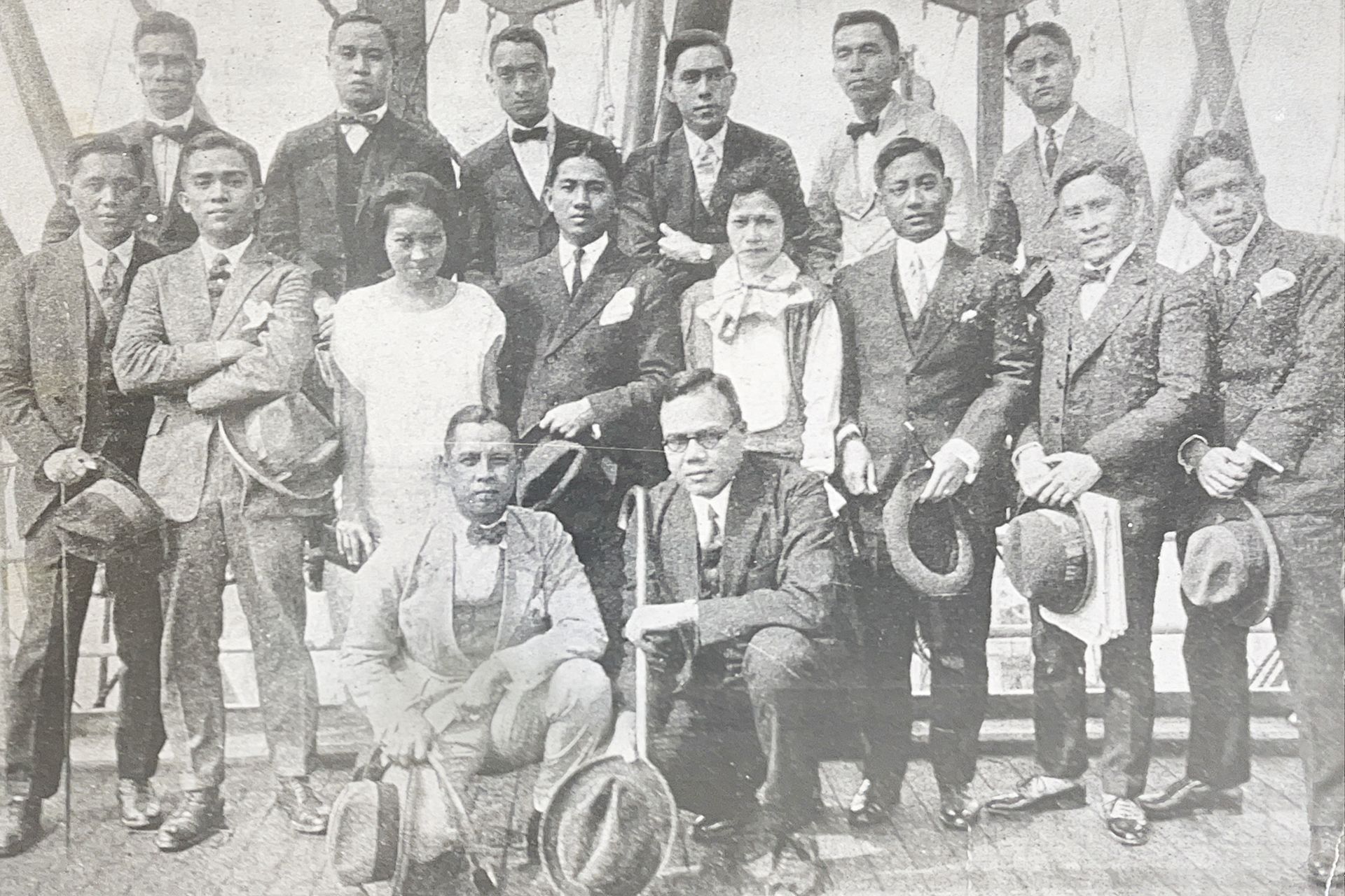 A black and white photo of a group of people posing for a picture.