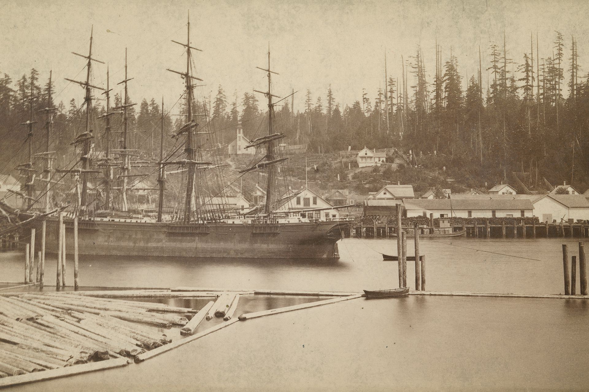 A black and white photo of a ship in the water